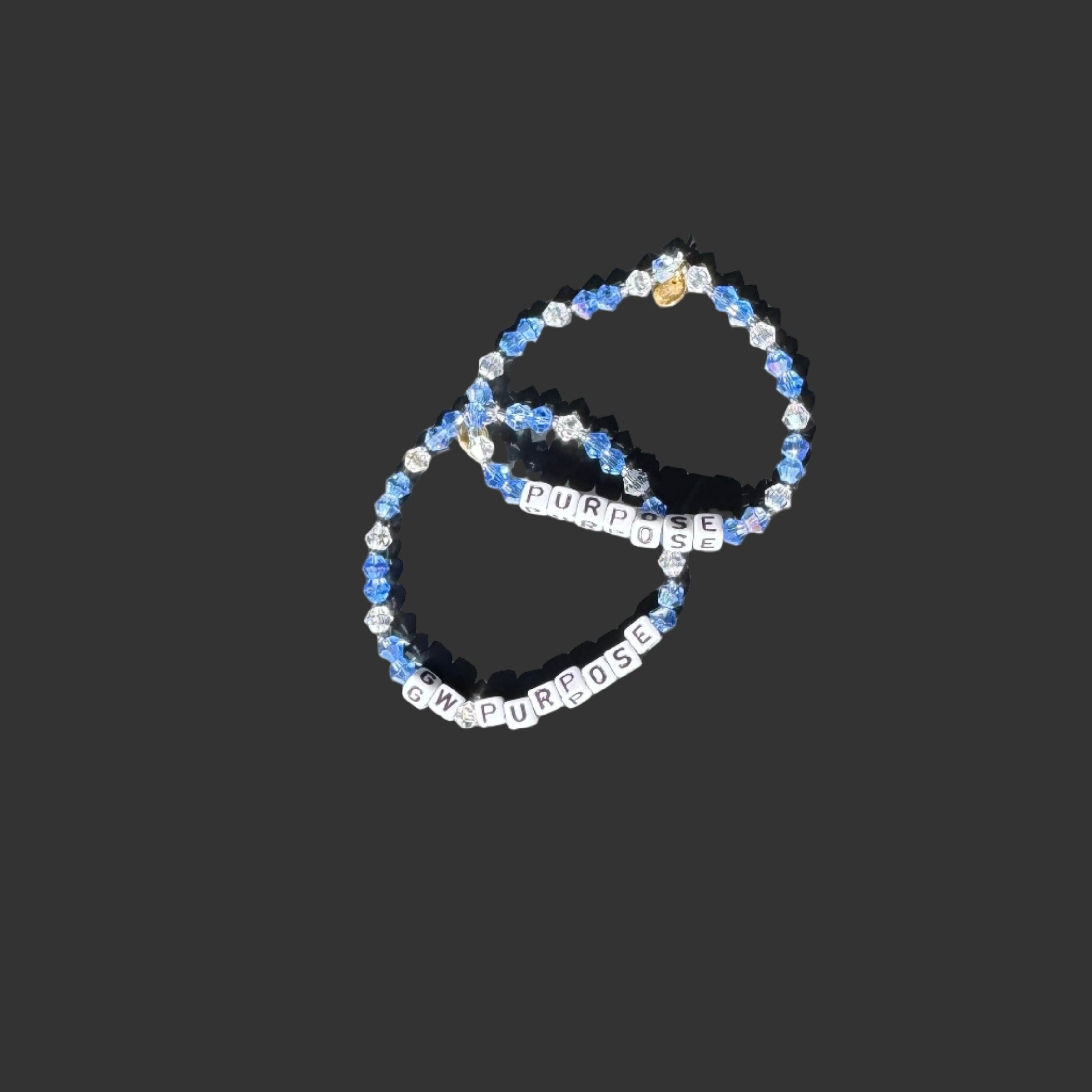 Two beaded bracelets with 'PURPOSE' text on a black background