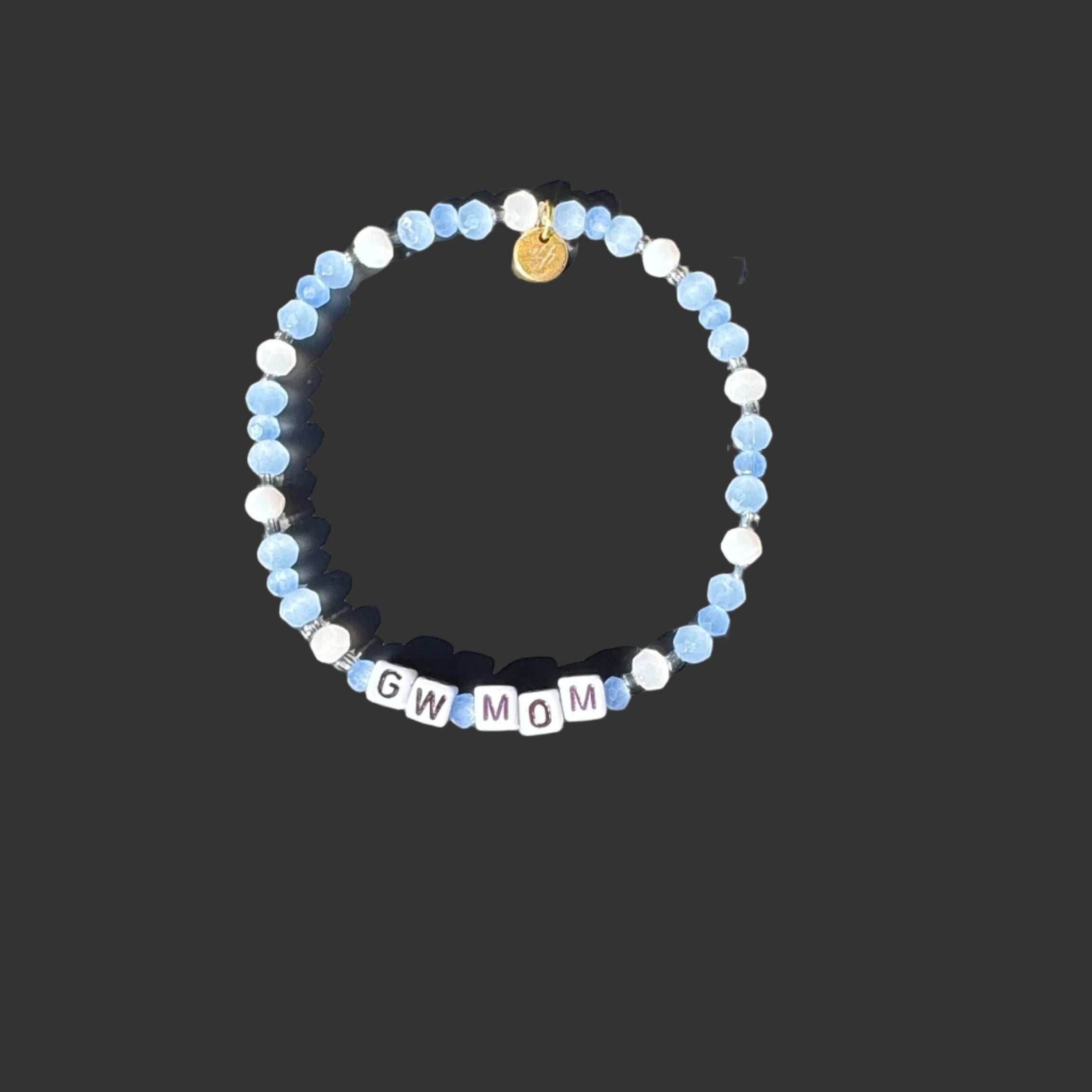 Bracelet with blue and white beads and letter beads on a black background