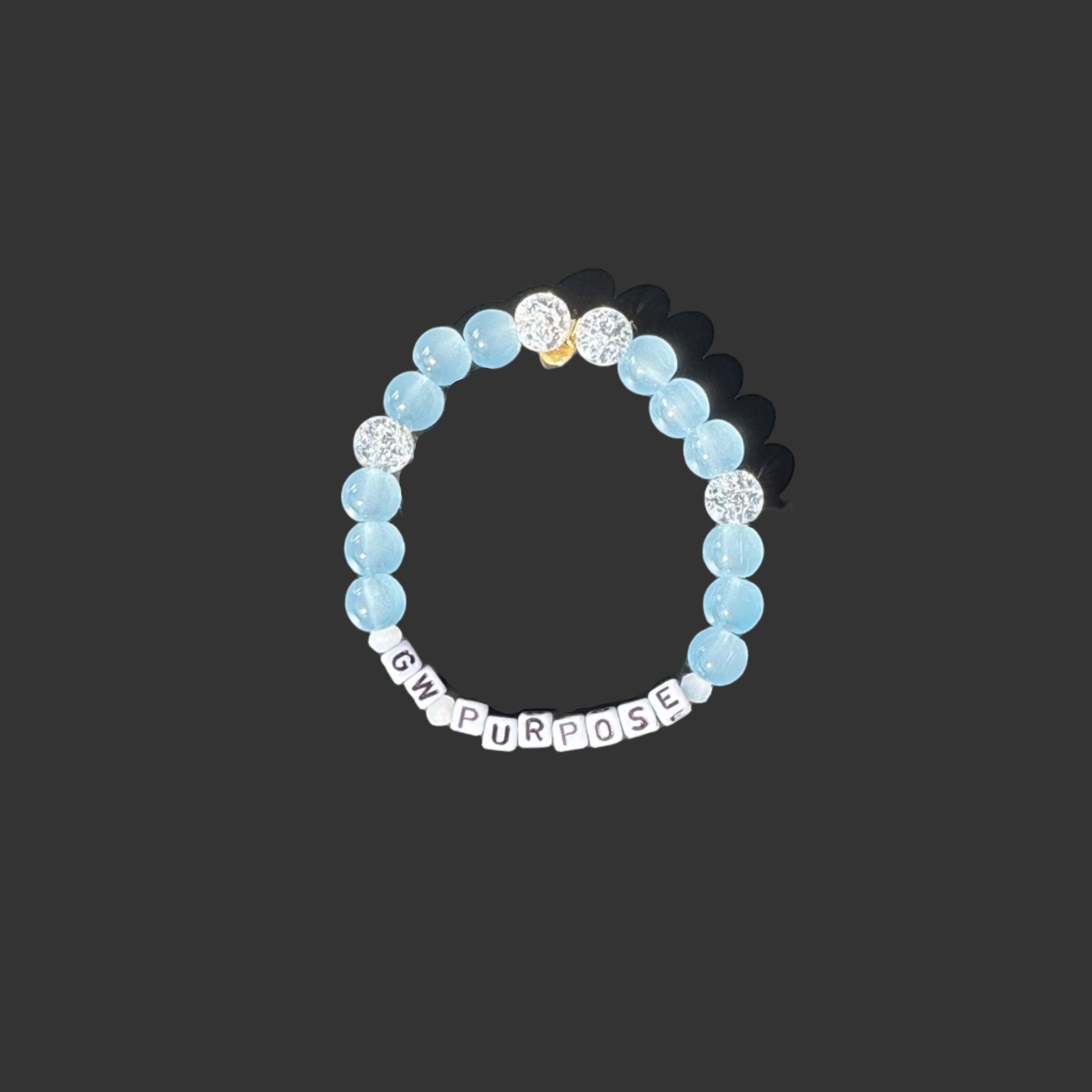 Bracelet with blue and white beads on a black background