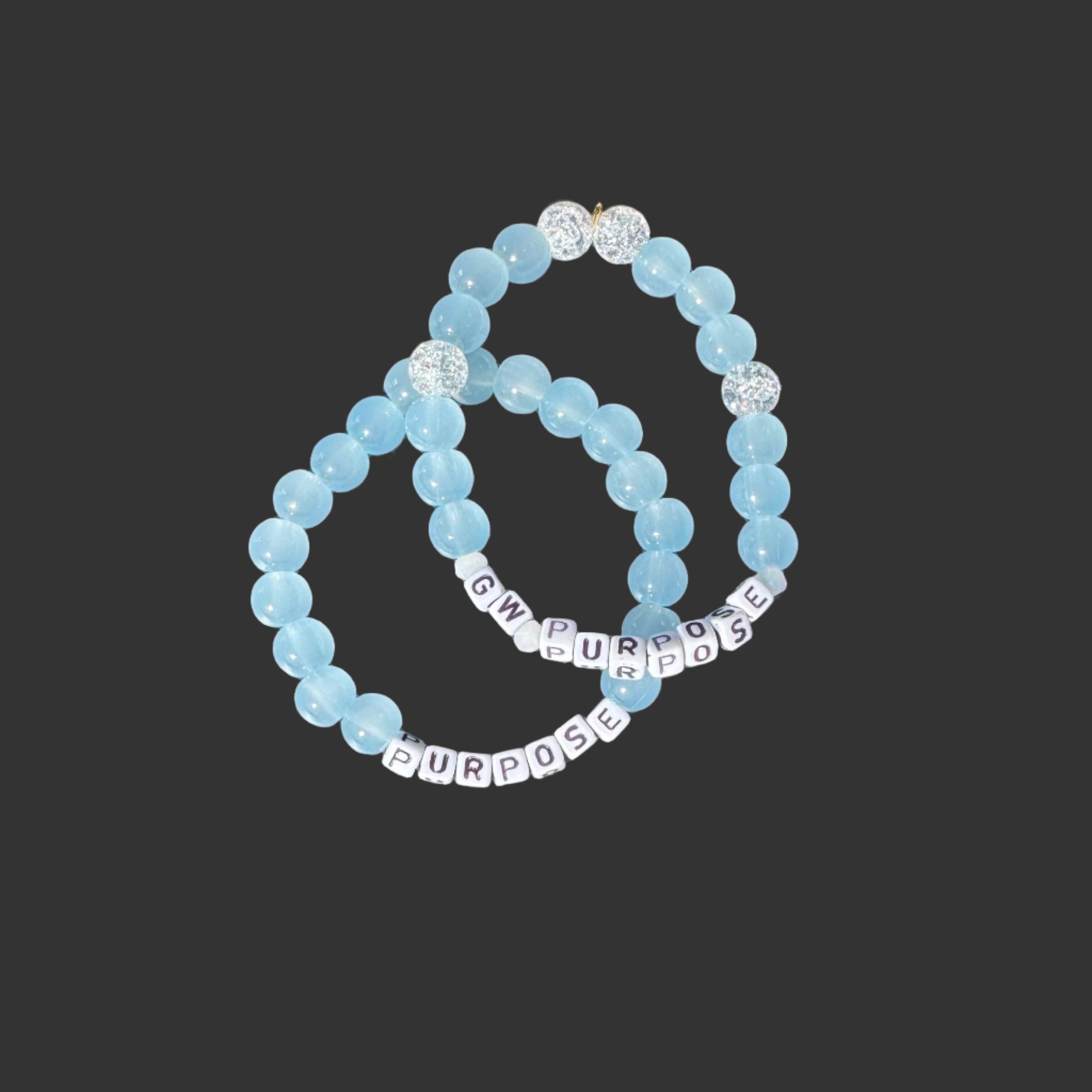 Three beaded bracelets on a metallic surface