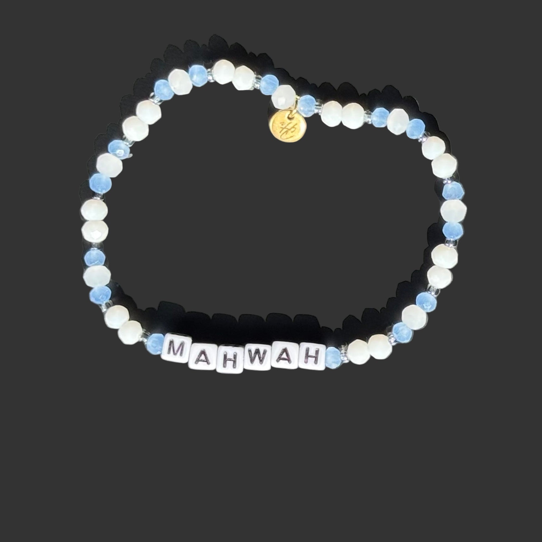 Beaded bracelet with 'MAHWAH' beads on a dark background