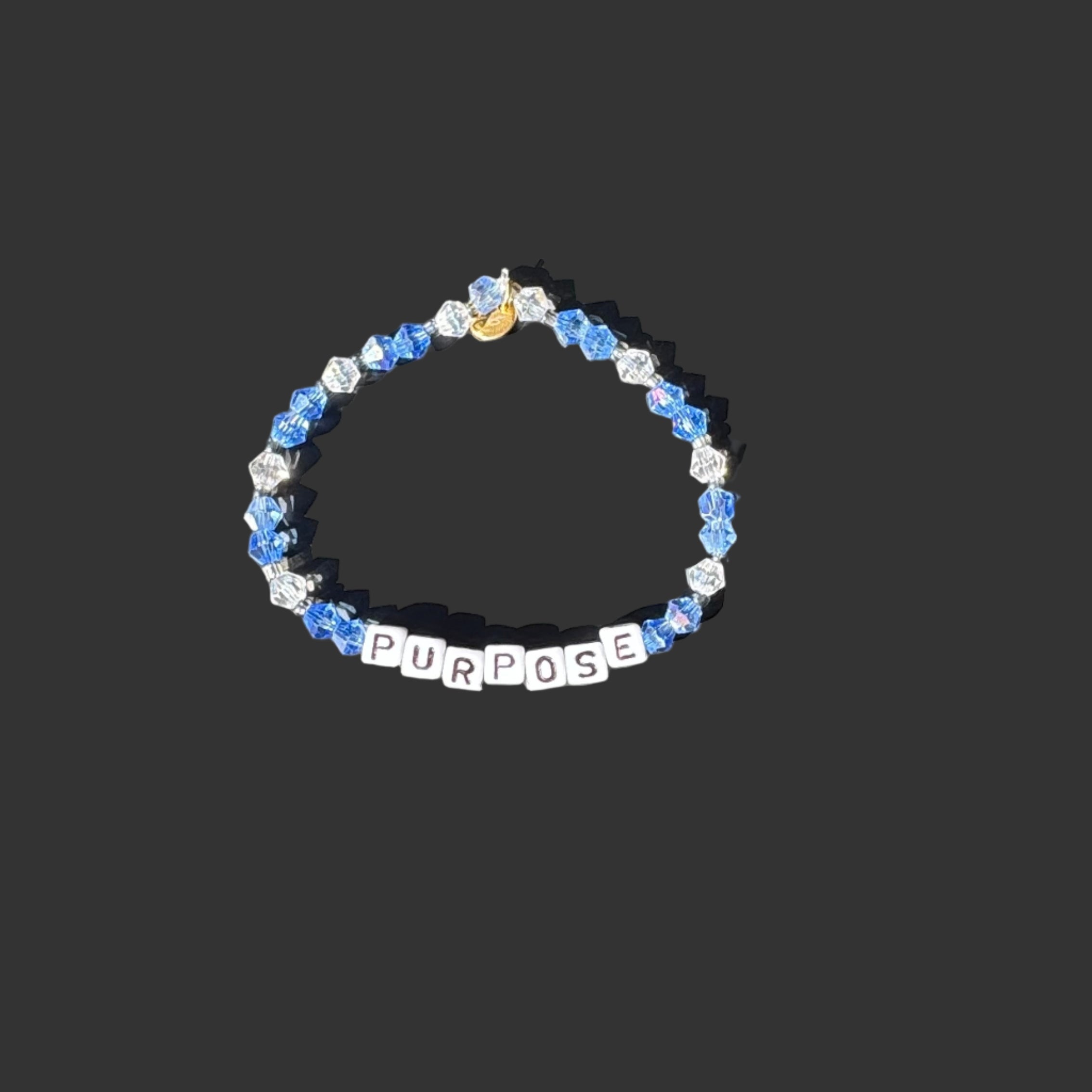 Bracelet with 'PURPOSE' beads on a black background